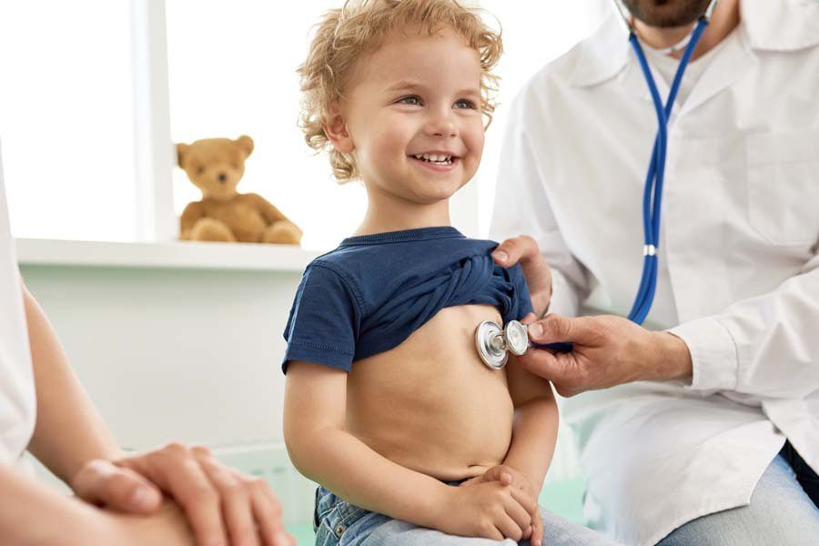 Short-Term Medical Insurance - Child with the Doctor an a Well Visit Appointment